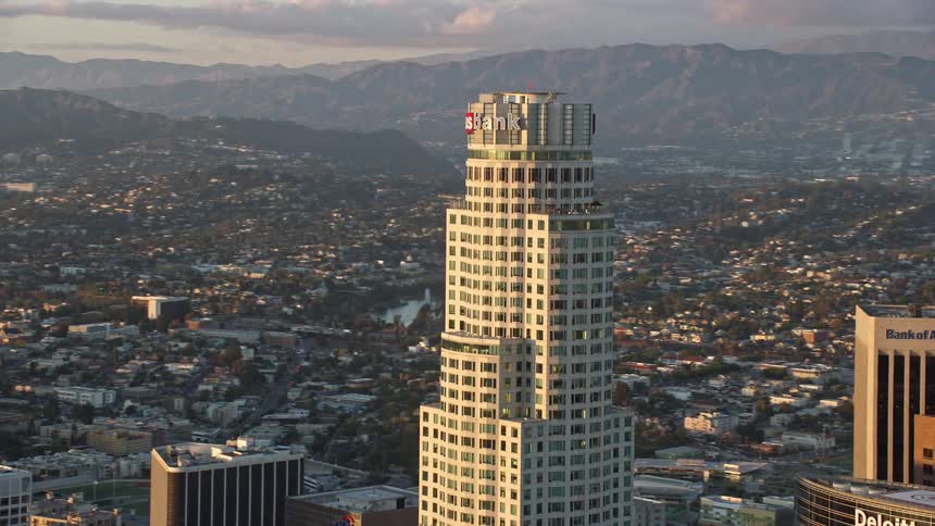 An epic aerial shot of US Bank Tower at sunset in Downtown LA showcasing the citys towering skyscrapers and stunning Southern California skyline