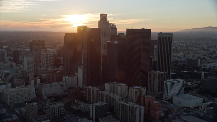 A stunning aerial view of the tall skyscrapers in downtown Los Angeles during sunset
