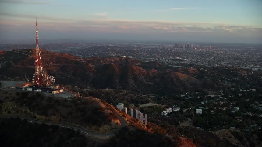 A mesmerizing aerial clip of the Hollywood Sign at twilight that gradually unveils the stunning downtown LA skyline and surrounding Santa Monica Mountains