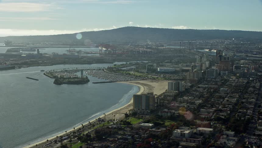 Aerial footage of Downtown Long Beach California displaying the marina office buildings and port during a hazy day