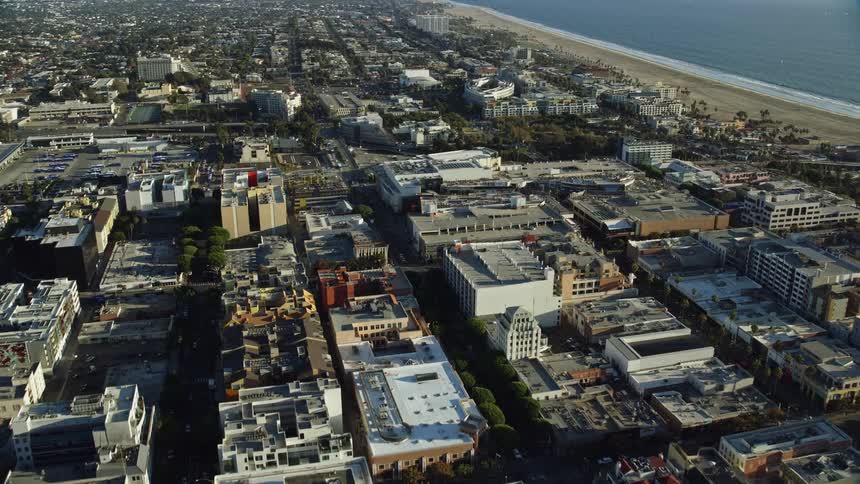 An aerial footage flying over office buildings and Santa Monica Place mall to approach RAND Corporation offices in Southern California on a sunny day