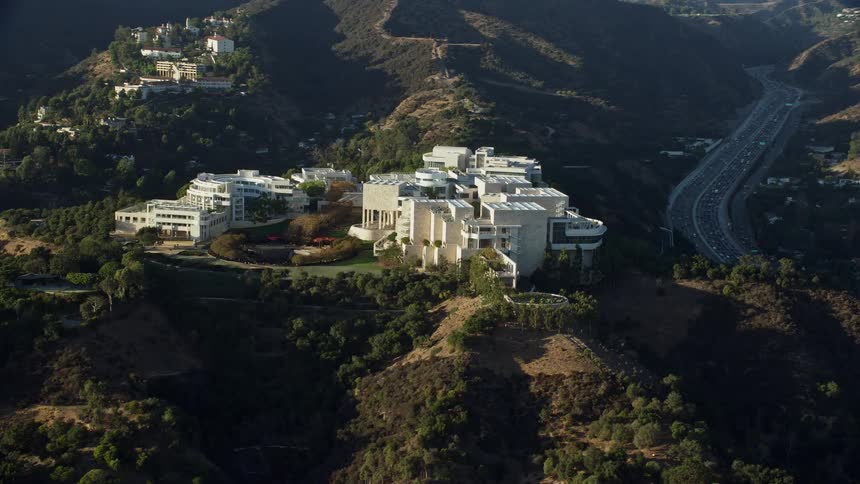 Aerial footage of the Getty Museum in Brentwood California showcasing its architecture and location on a hilltop with plenty of sunshine and shot with a Shotover F1 on an Epic Helium camera during spring or summer