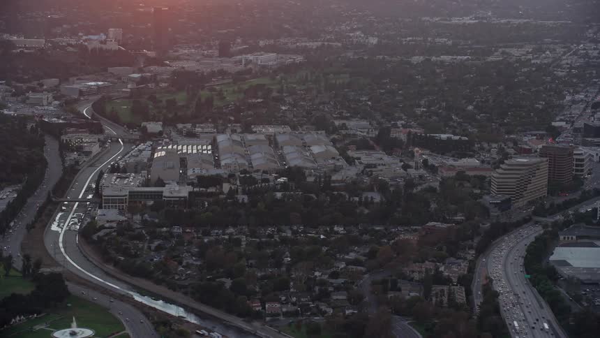  aerial footage of sunset over the Warner Bros Studio lot in Burbank California offering a side view of the bustling film and entertainment epicenter of Southern California