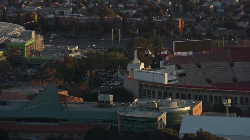 A LAPD helicopter tracks over USC in University Park Los Angeles during daytime