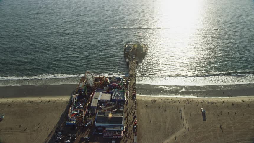 Experience the iconic Santa Monica Pier from a birds eye view in sunny Southern California with an epic shot captured during daytime using overhead footage technology