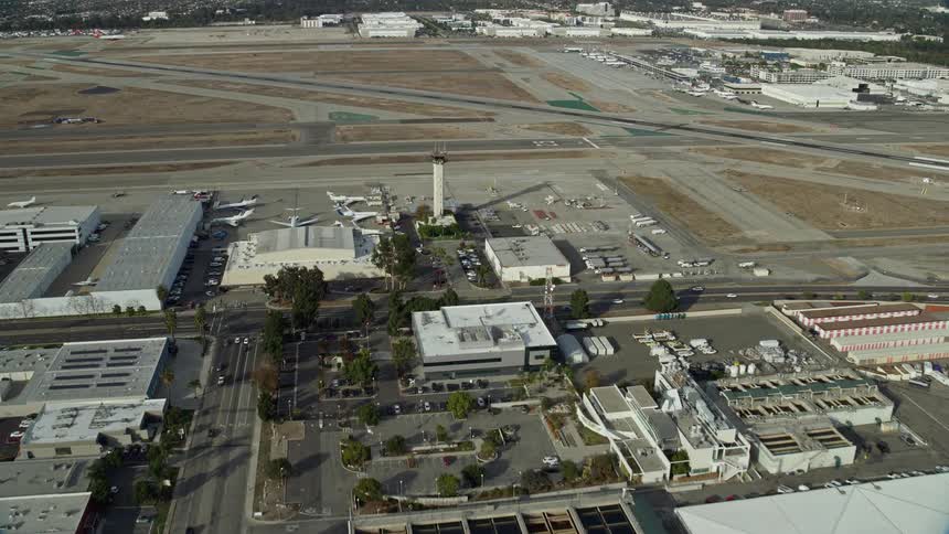Approaching the control tower and runways at Long Beach Airport in Southern California during partly cloudy skies