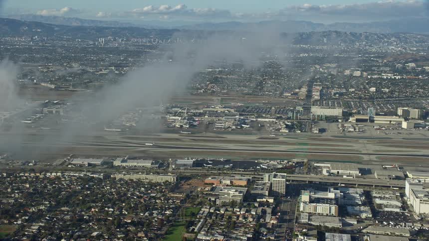 Approaching LAX airport through partly cloudy skies in California during the summer
