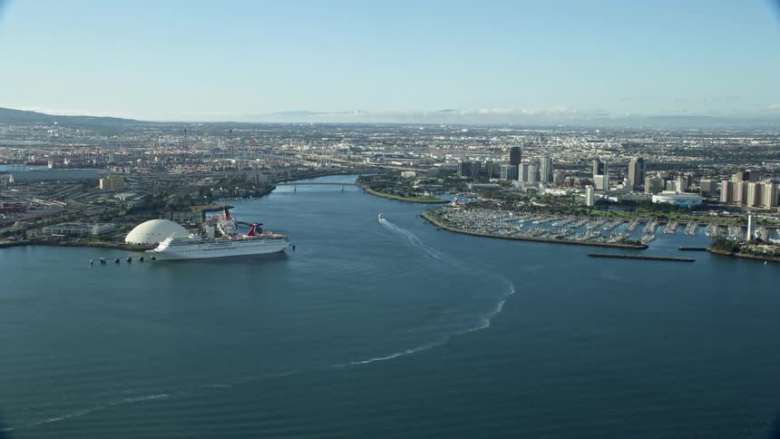Stunning aerial footage capturing the waterfront industrial area port of Long Beach Los Angeles River and downtown Long Beach during a sunny day in Southern California