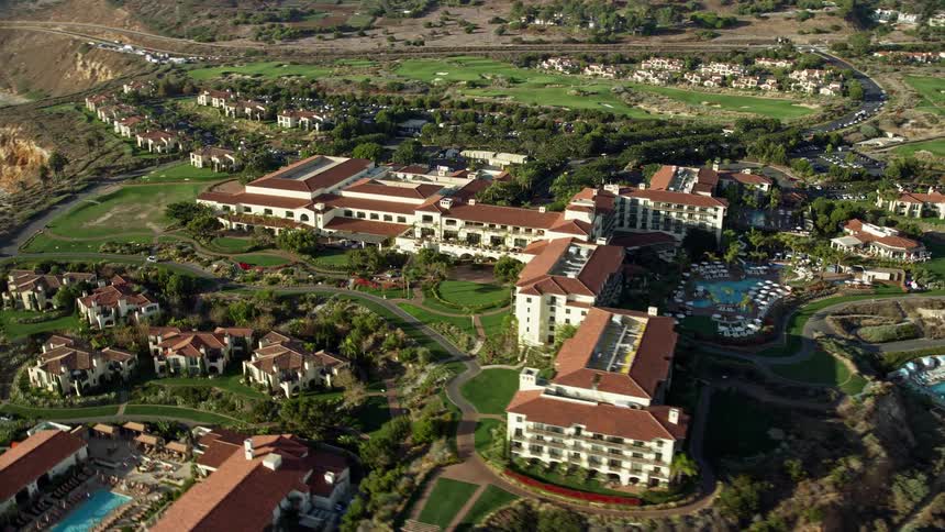 Aerial footage of the Terranea Resort in Rancho Palos Verdes California showcasing the resorts serene coastal location and beautiful lodgings during summer