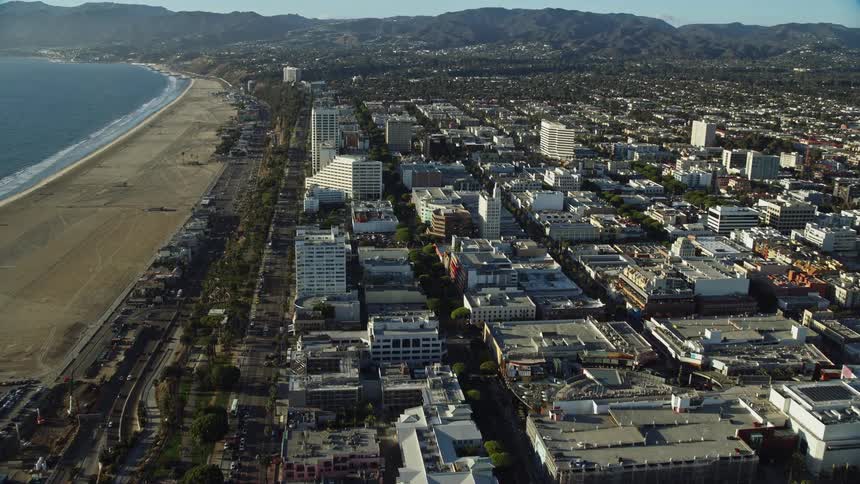 Flying over Santa Monica beach to approach shops and Santa Monica Place mall in sunny Southern California