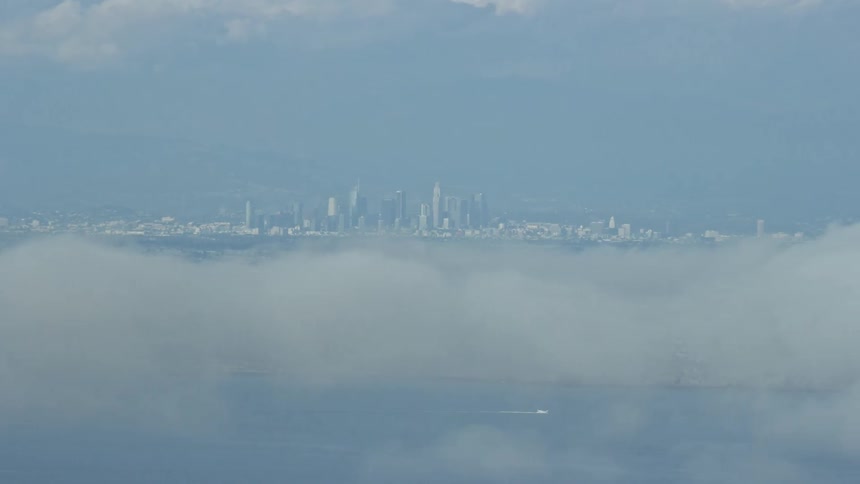 View of Downtown Los Angeles skyline from Catalina Island with partly cloudy skies on a sunny day