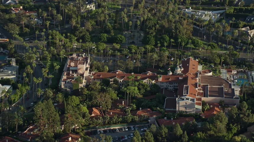 Aerial footage of the Beverly Hills Hotel in California shot during the day with scenic views of the surrounding area