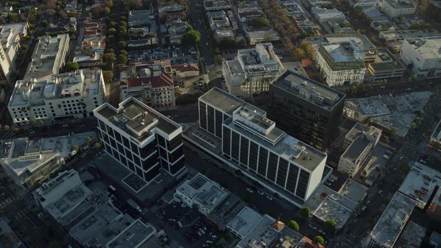 Aerial footage of office buildings and retail centers in Californias iconic Beverly Hills shot during daytime and in good weather