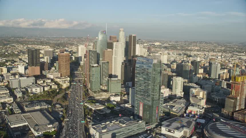 A breathtaking aerial footage of Downtown Los Angeles showcasing the tall skyscrapers during a partly cloudy day shot over by the Shotover F1