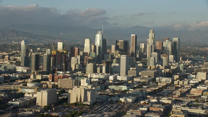 Stunning aerial footage captures the majestic high rises and skyscrapers of Downtown Los Angeles during a partly cloudy day