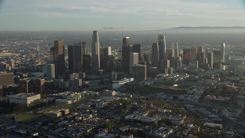 A shot of hazy Downtown Los Angeless skyscrapers as seen from the air on an epic Helium shot during a clear summer day