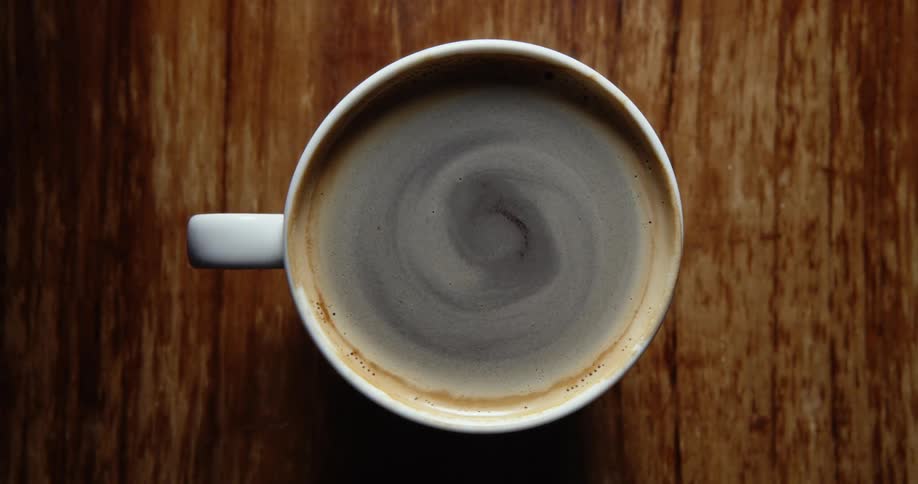 Hot coffee swirls in a mug