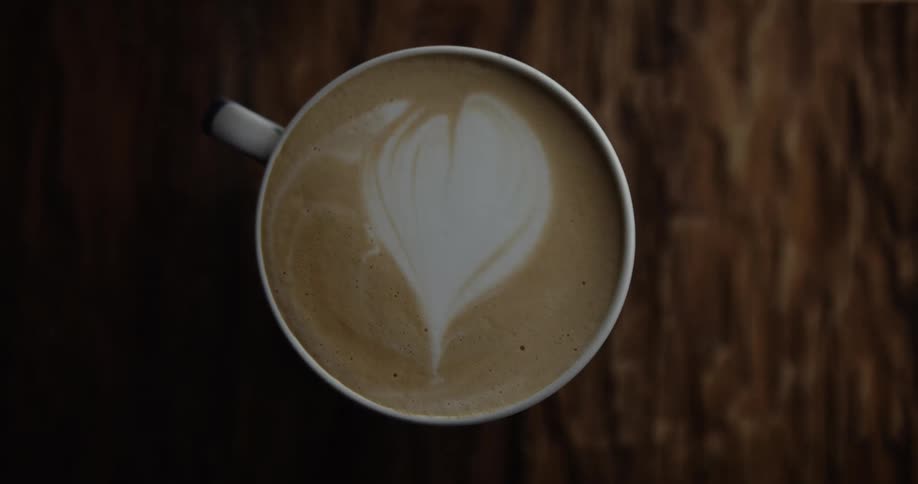 Top shot of a latte coffee with a white foam heart