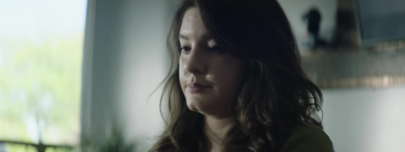 Woman with wavy hair uses computer