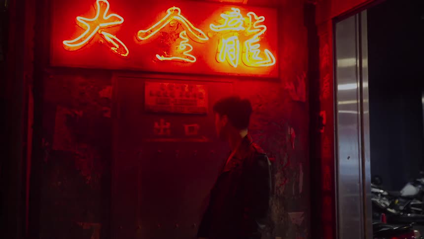 A man reads a sign at a business near an elevator