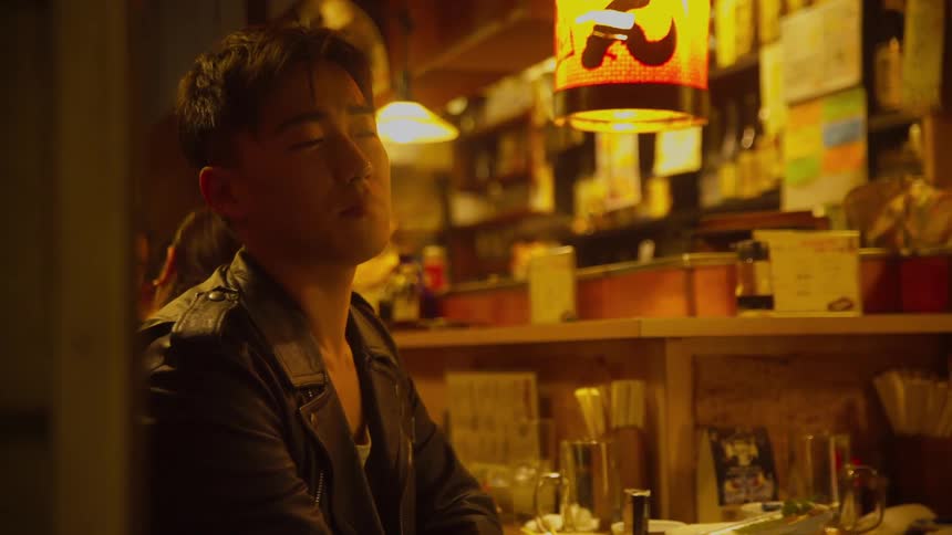 People are sitting at a bar and smoking cigarettes