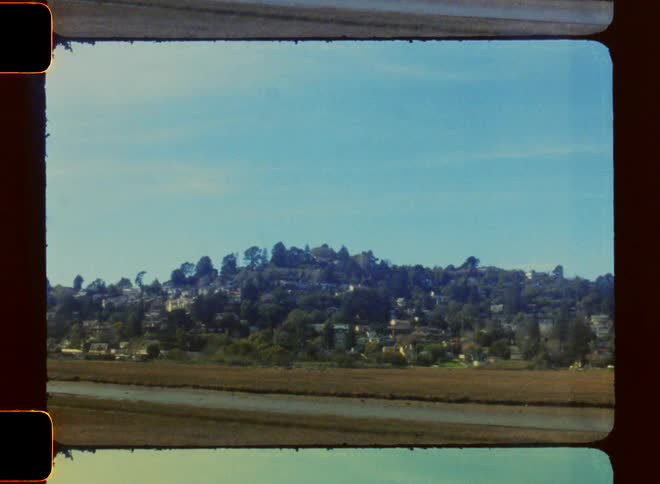 Wide archival portrait of hollywood hills view from 5 freeway onramp during the day