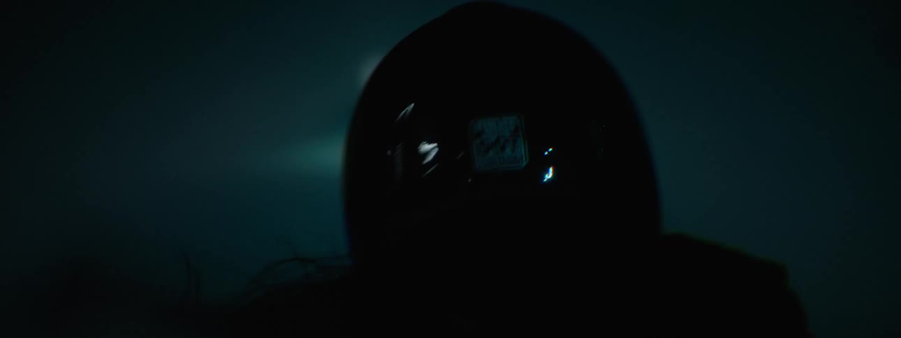 Woman with helmet and leather jacket rides motorcycle fast at night