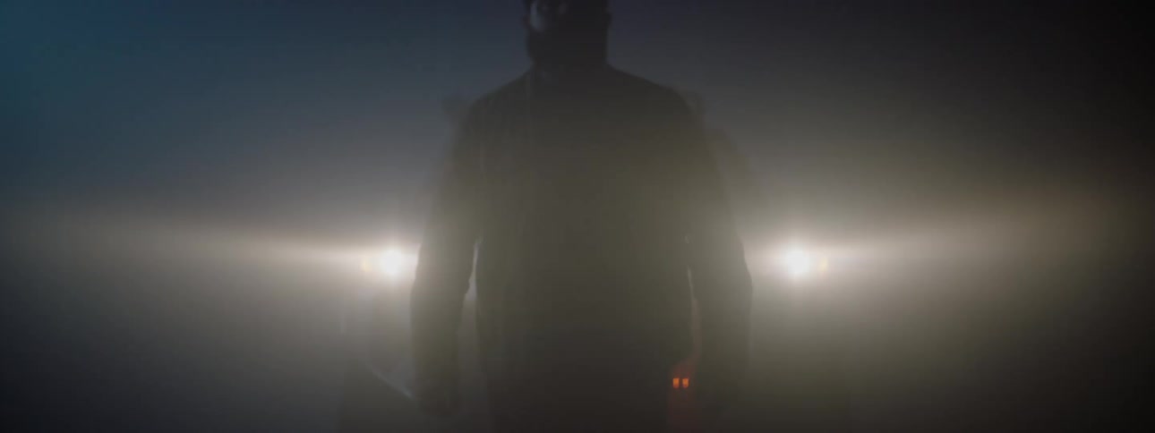A man walks away from the back of his vehicle