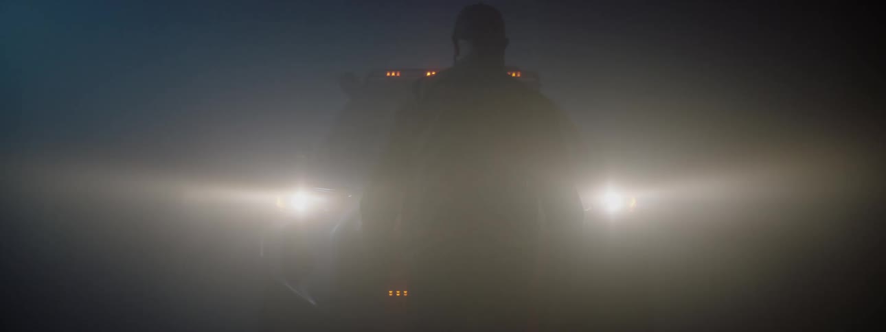 A man walks up to the truck in the fog