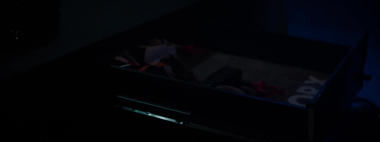 Man loading cargo area of suv at nighttime with professional gear and tools