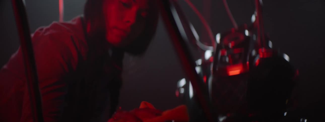 A woman is holding a white cloth and wiping the seat of her motorcycle