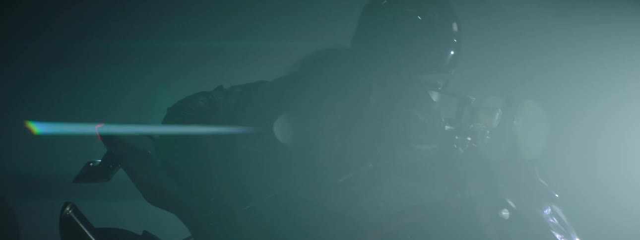 A woman is riding a motorcycle during the night