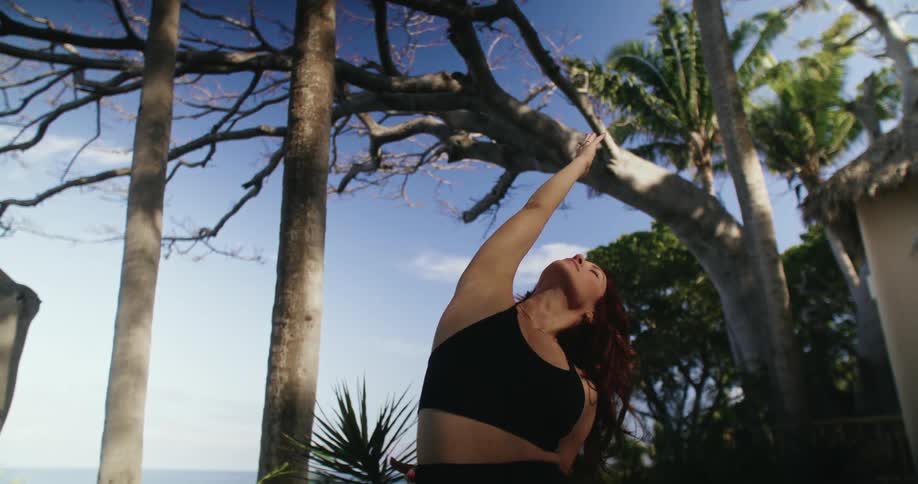 A woman is doing yoga in the yard