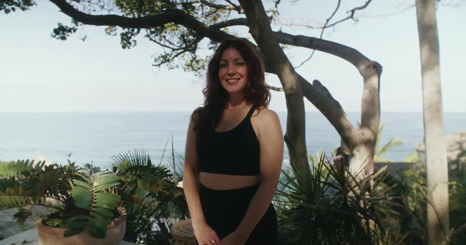 Portrait of a woman standing in a tropical area