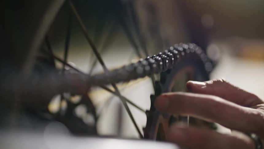 A man checks the chain on his bicycle
