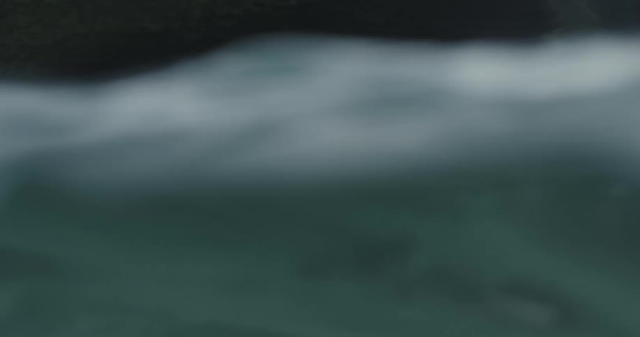 A man paddling out in the ocean