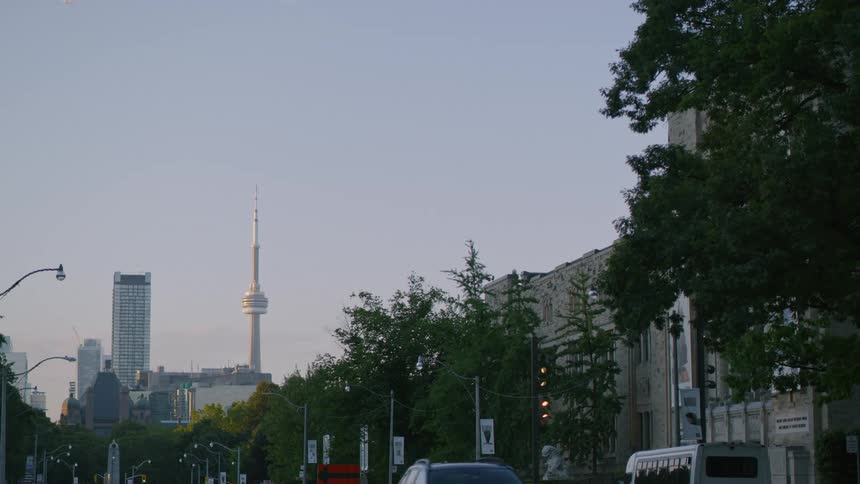 Vehicles drive down a street heading into and away from downtown