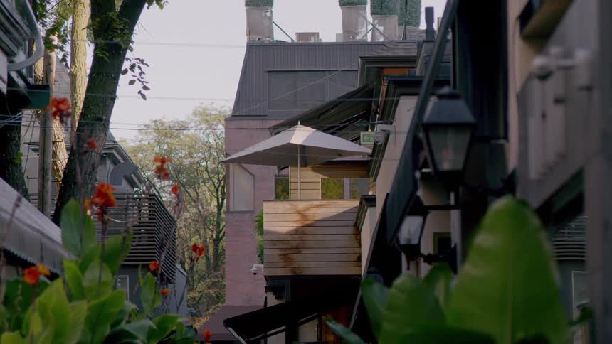 A woman walks between the homes