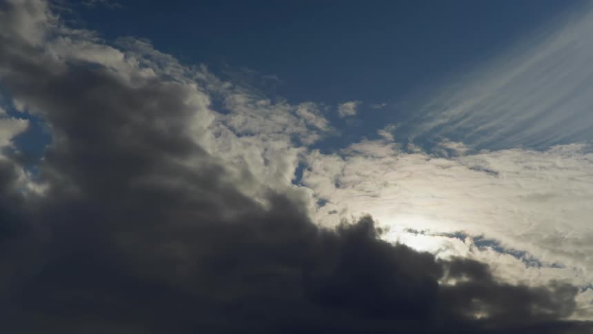 Aerial view of the sun setting in the cloudy sky