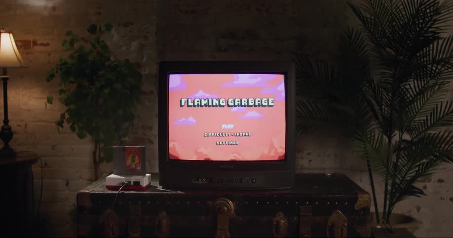 Vintage television set briefly displays a videogame on screen before showing static