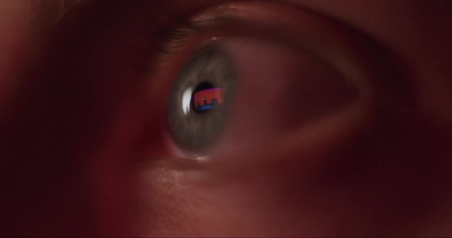 An extreme close up of a persons eye with reflections in it