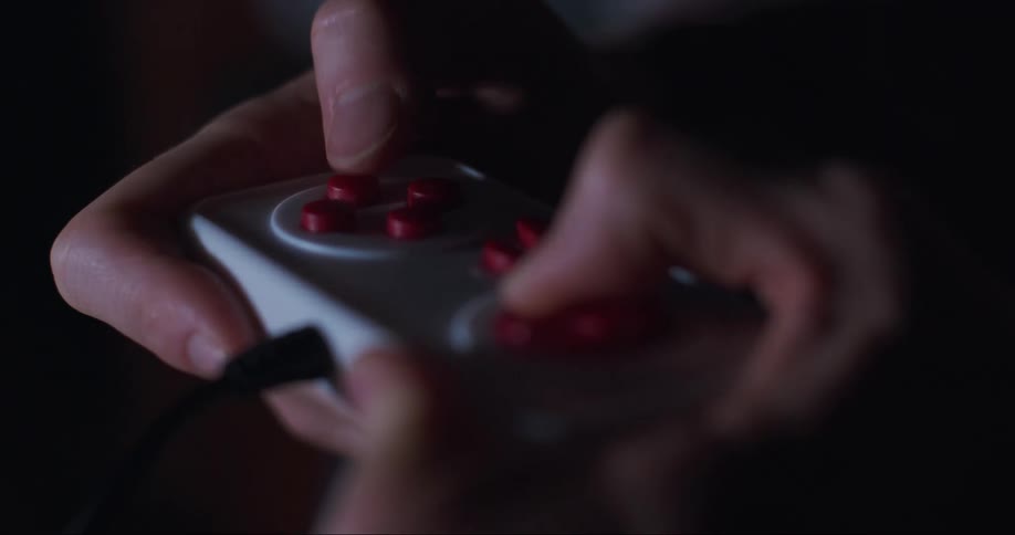 Mans hands uses video game controller