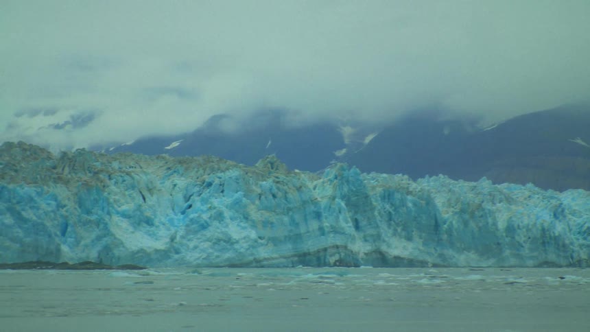 Landscape of distant mountains and glacier next to the sea