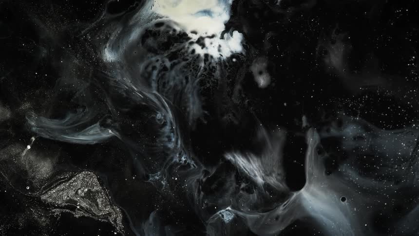 White swirls form a marble pattern against a black surface