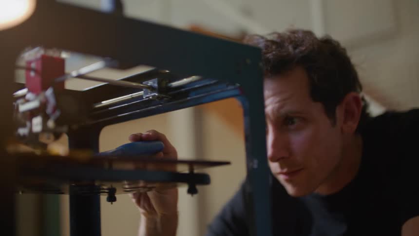 A man doing something with a machine