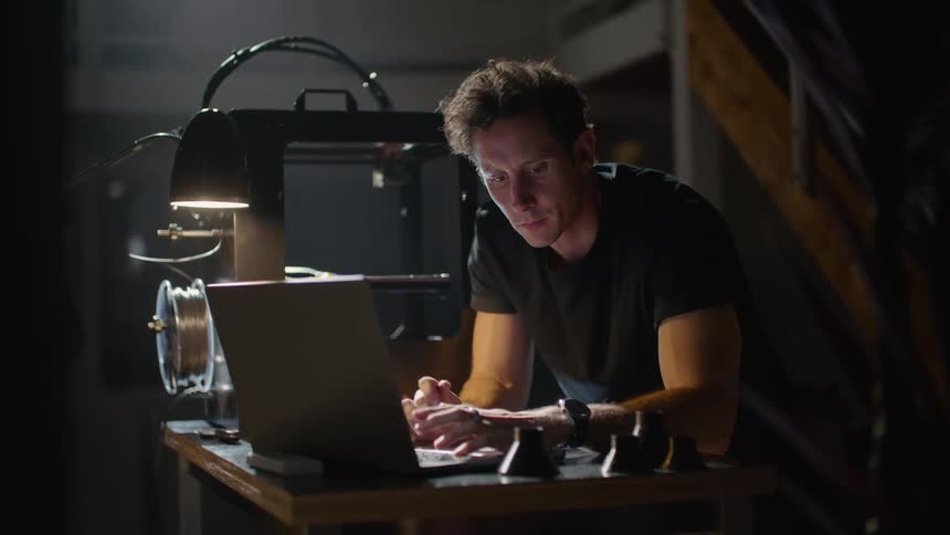 A man using a laptop in a room