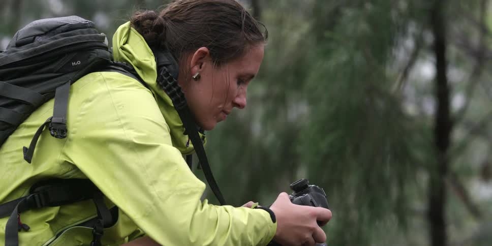 A woman is looking at her camera