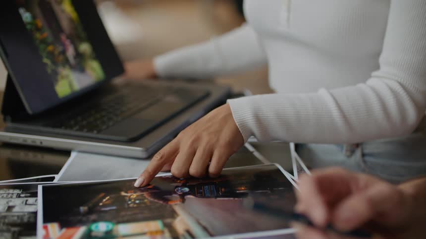 Coworkers working in office discuss pictures