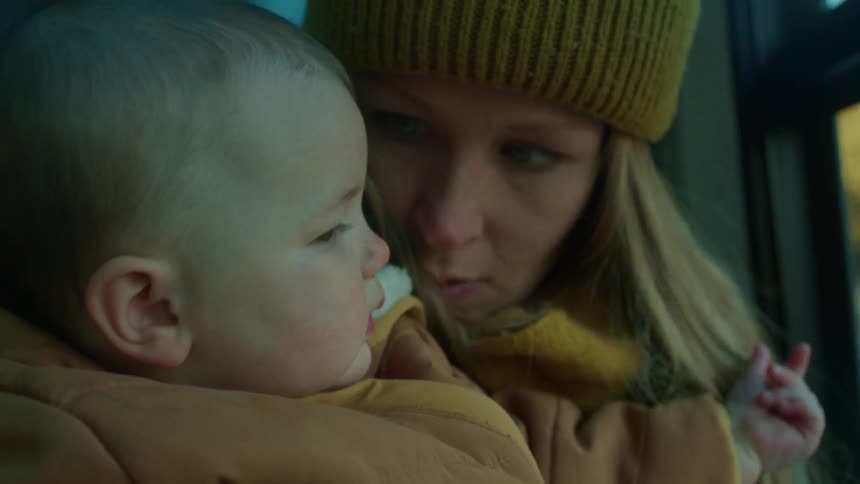 A close up of a mother holding her baby daughter