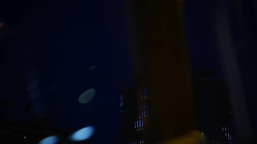 A high rise building is lit up at night